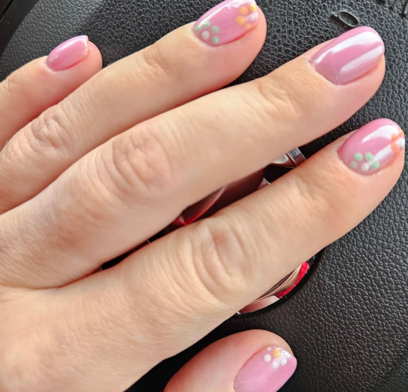 Pink manicure with delicate floral nail art at Kat's Beauty